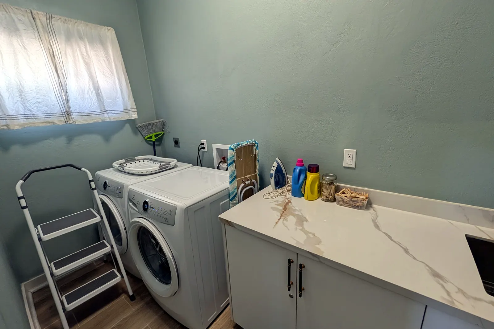 Laundry room with washer, dryer and a marble-look counter