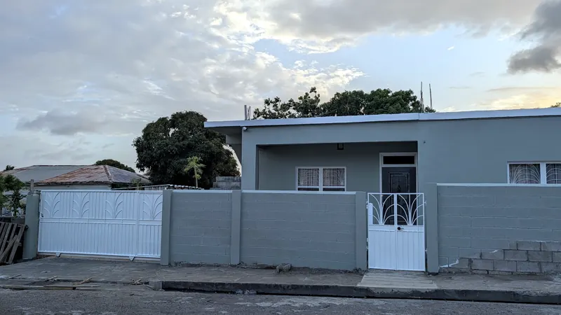 Trafalgar Road at dusk with the house behind its wall